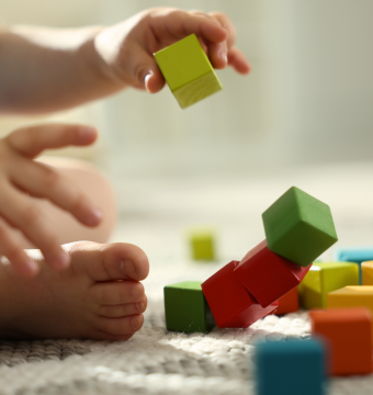 Kind spielt mit bunten Holzklötzen